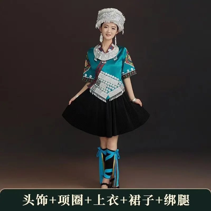 Miao embroidery suit featuring vibrant colors, intricate details, worn by a woman in traditional festival costume.