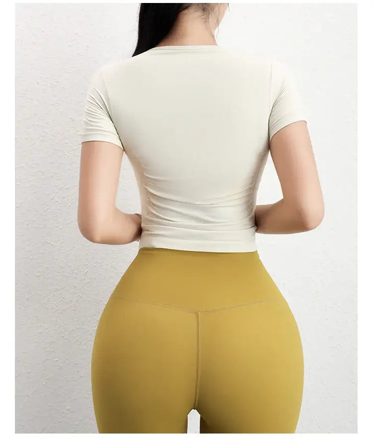 قميص رياضي نسائي ضاغط بأكمام قصيرة بدون درزات