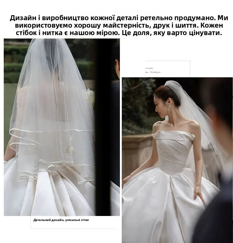 Elegant bride showcasing a satin off-shoulder wedding gown with a long veil and unique design details.