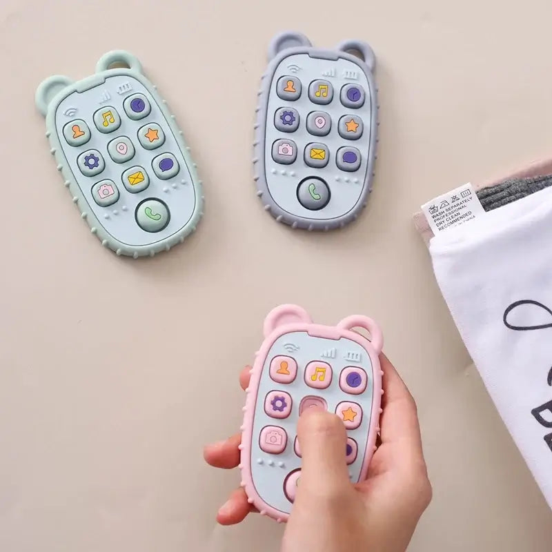 Colorful baby remote controls in bear shape, designed for kids with soft buttons for sensory play.