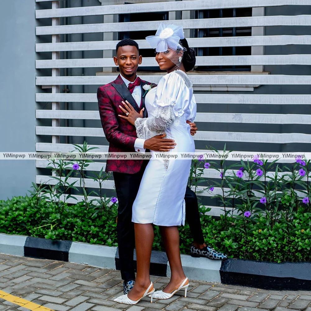 Couple embracing in elegant wedding attire, showcasing a stylish white dress with unique details and a handsome suit.