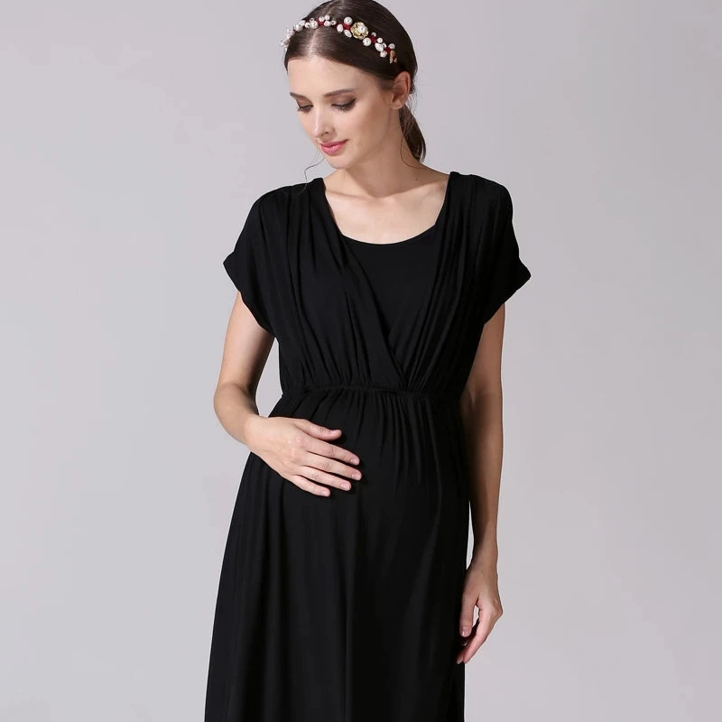 Model wearing a soft black fabric maternity nursing dress by Emotion Moms, designed for comfort and breastfeeding.