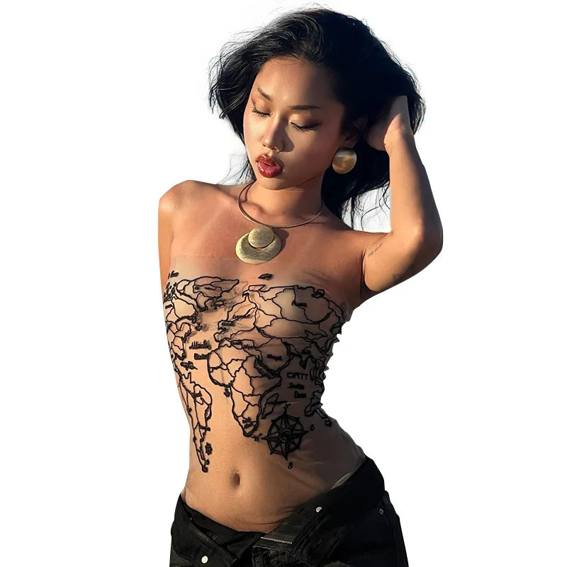 Stylish woman showcasing body art with world map design, wearing statement accessories and posing confidently.