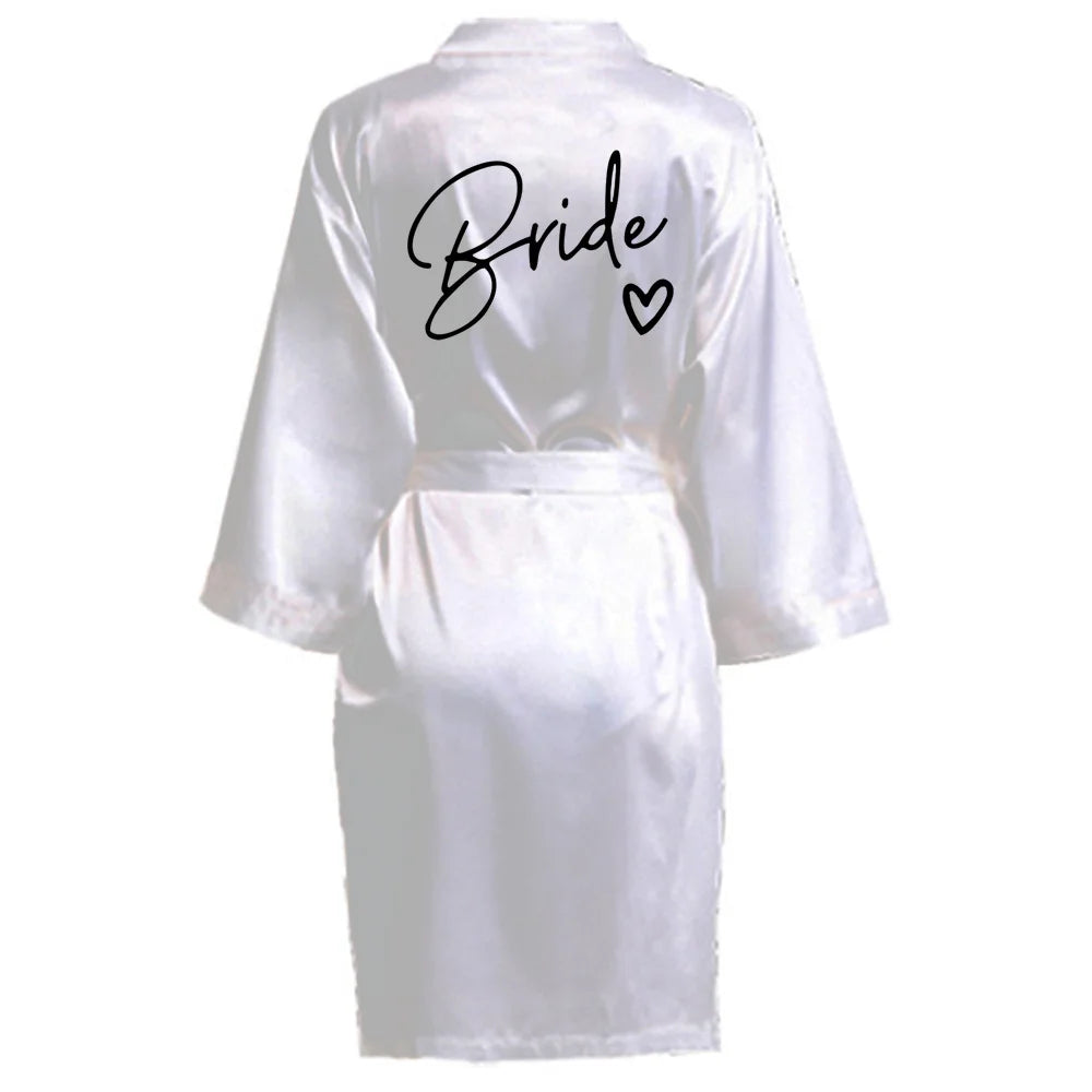 Elegant white satin robe with 'Bride' printed on the back, perfect for bridal parties and celebrations.
