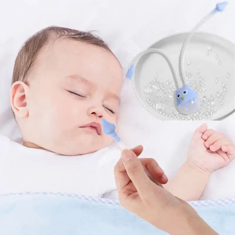 Baby sleeping while using a cartoon owl nasal aspirator, designed for gentle nasal relief.
