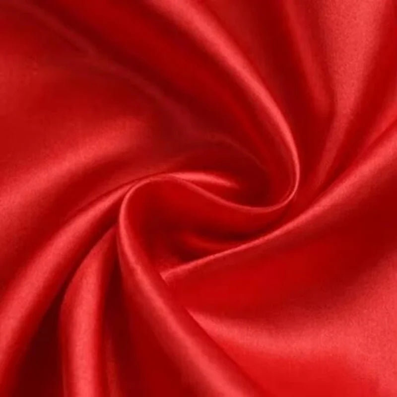 Close-up of luxurious red satin fabric, showcasing its smooth texture and elegant sheen.