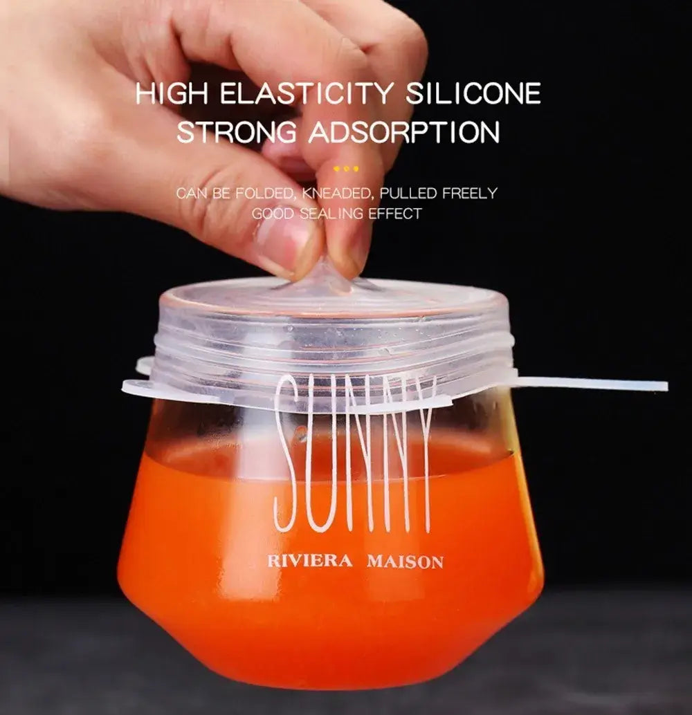 Hand holding a silicone stretch lid over a jar, demonstrating high elasticity and strong sealing for kitchen use.
