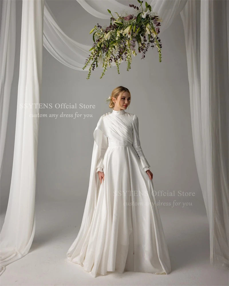 Elegant Muslim wedding dress with pearls, high neck, long sleeves, and floor-length satin skirt.