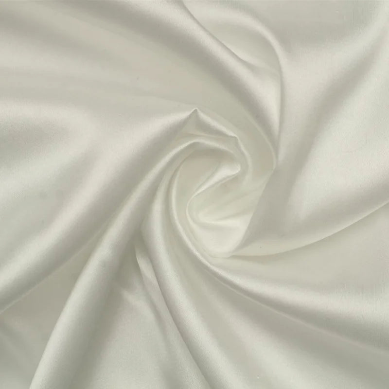 Close-up of elegant white satin fabric, smooth and lustrous, ideal for luxury clothing and bridal accessories.