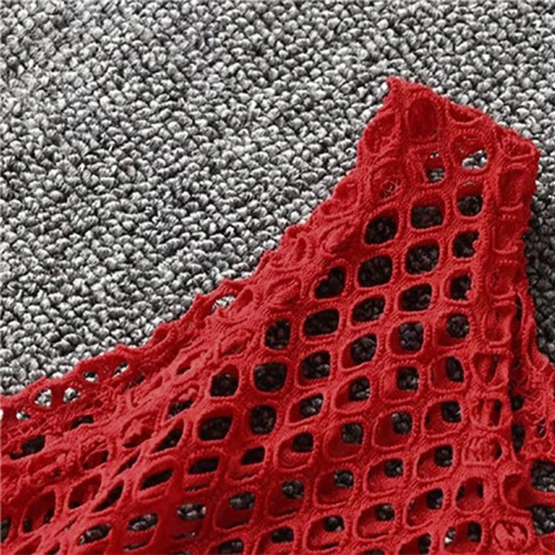 Close-up of the red fishnet material of a MeshGlow™ summer crop top, showcasing its breathable and hollow-out design.