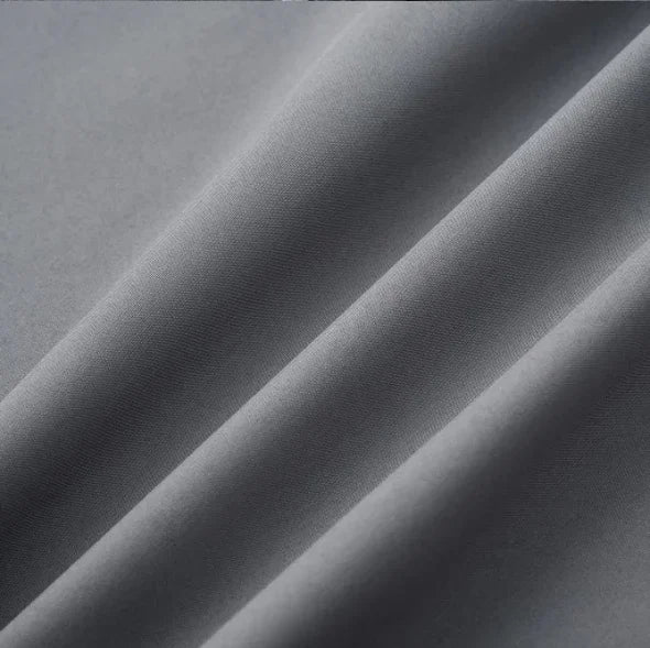 Close-up of elegant gray satin fabric showcasing smooth texture and subtle sheen, ideal for clothing like camisoles.