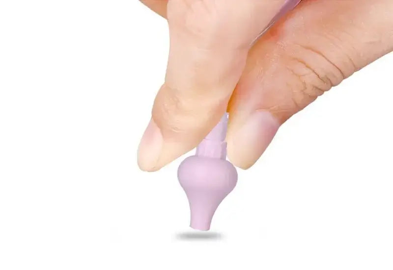 Hand holding a purple silicone nasal aspirator for babies, ideal for clearing nasal congestion.