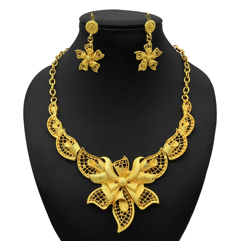 Luxury Indian bridal jewelry set featuring a 24K gold plated necklace and matching flower earrings.