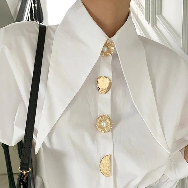 Close-up of PearlEdge™ chic shirt featuring elegant pearl-button detail and statement collar in a stylish design.