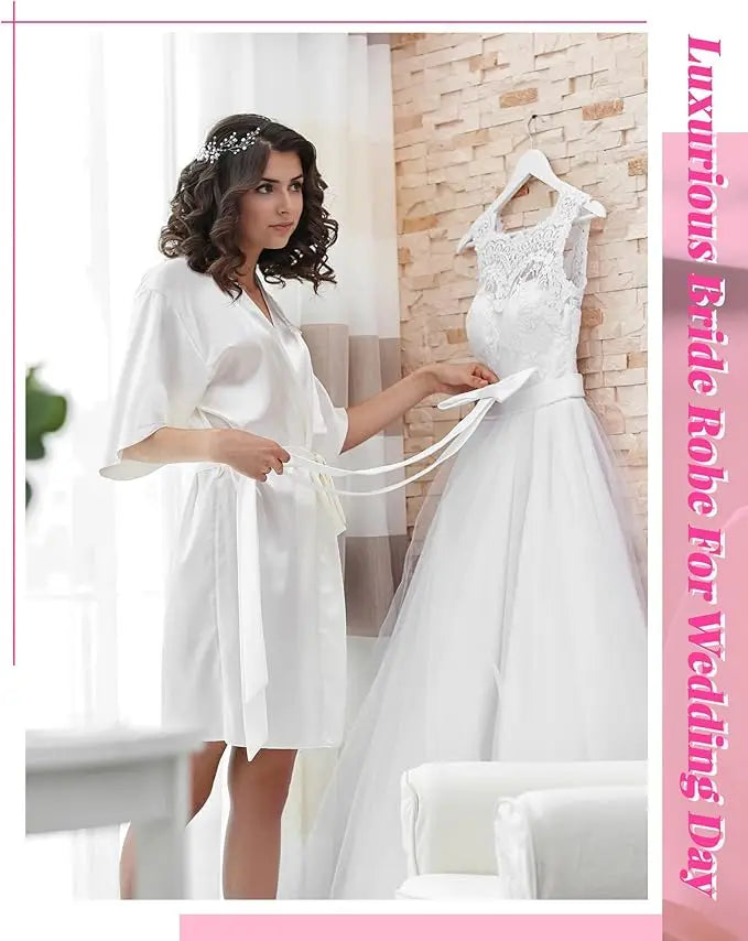 Luxurious bride in a satin robe preparing for her wedding day, showcasing a beautiful wedding gown.