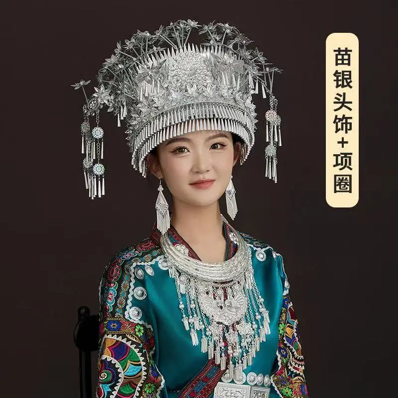Miao woman in traditional festival costume with intricate silver accessories, showcasing cultural heritage and craftsmanship.