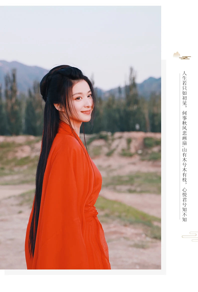 Woman wearing a traditional red Hanfu dress, showcasing Chinese embroidery, set against an outdoor backdrop.