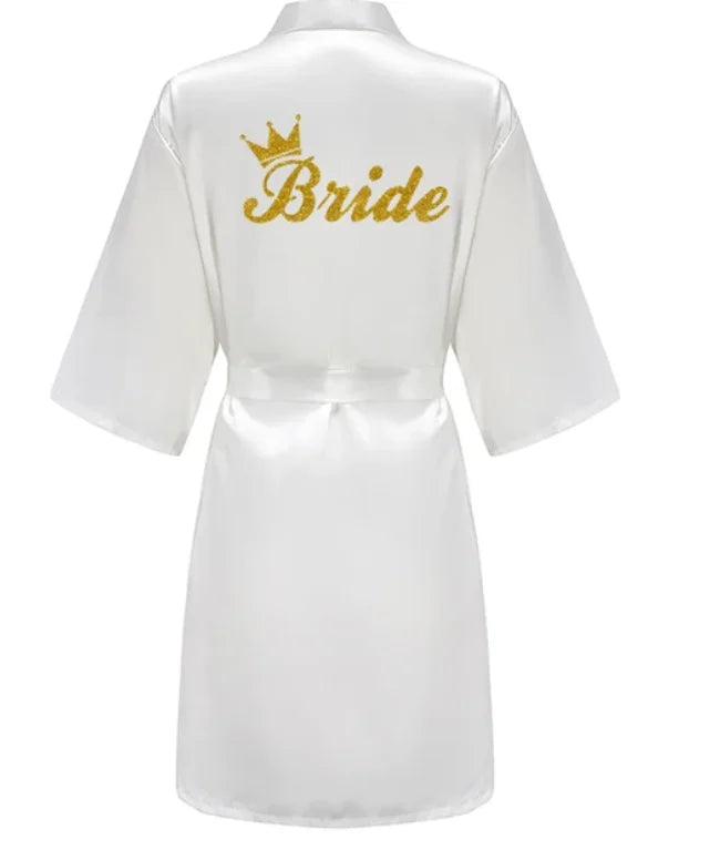 Back view of a white satin bridal robe with gold glitter text 'Bride' and crown design, perfect for wedding celebrations.