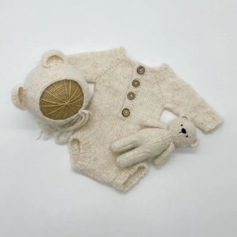 Newborn photo romper set with bear bonnet and toy, ideal for baby photography props.