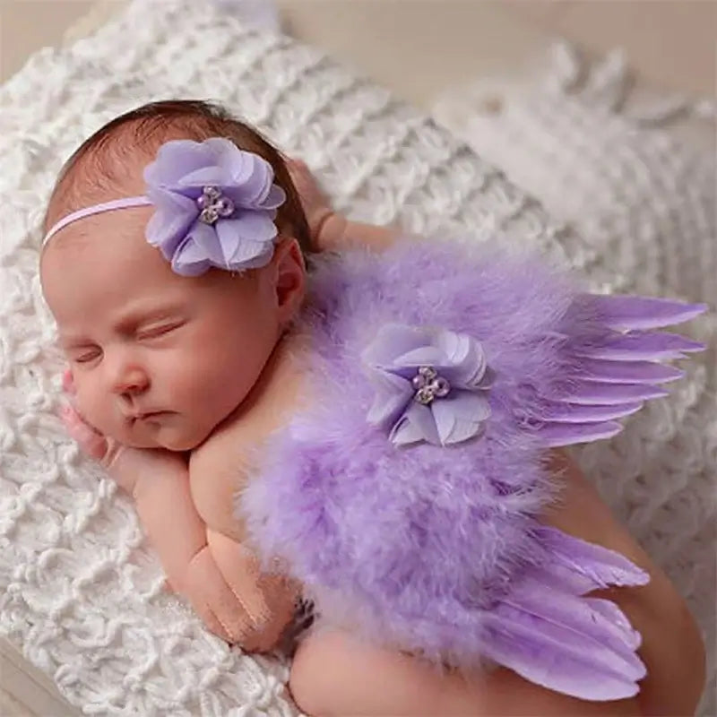 Newborn in purple angel wings and headband, perfect for baby photography props and cute photo shoots.