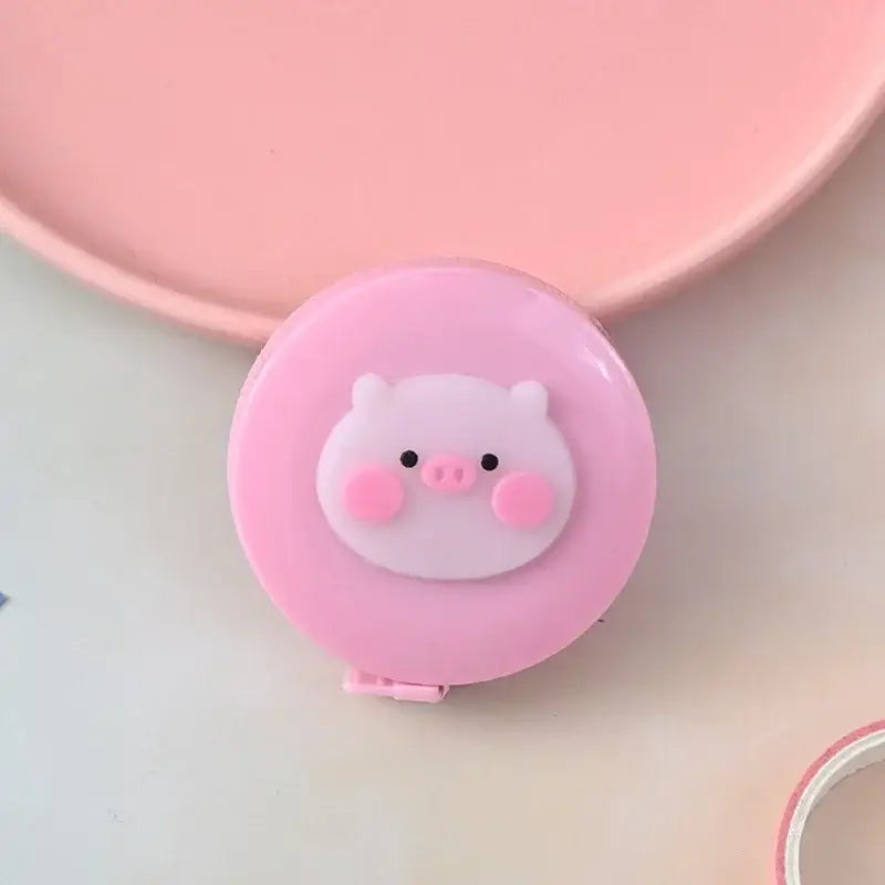 Cute pink pig-themed measuring tape with round design, perfect for kids and creative projects.