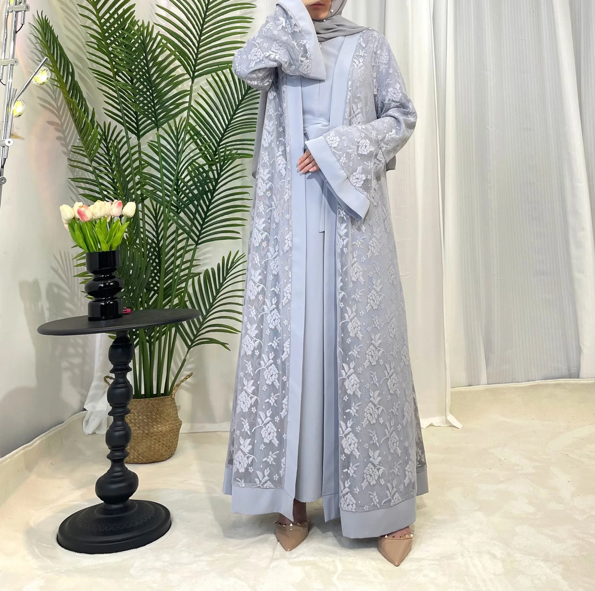 Model wearing a stylish Dubai Moroccan Kaftan in grey, showcasing elegant Islamic dress with floral design.