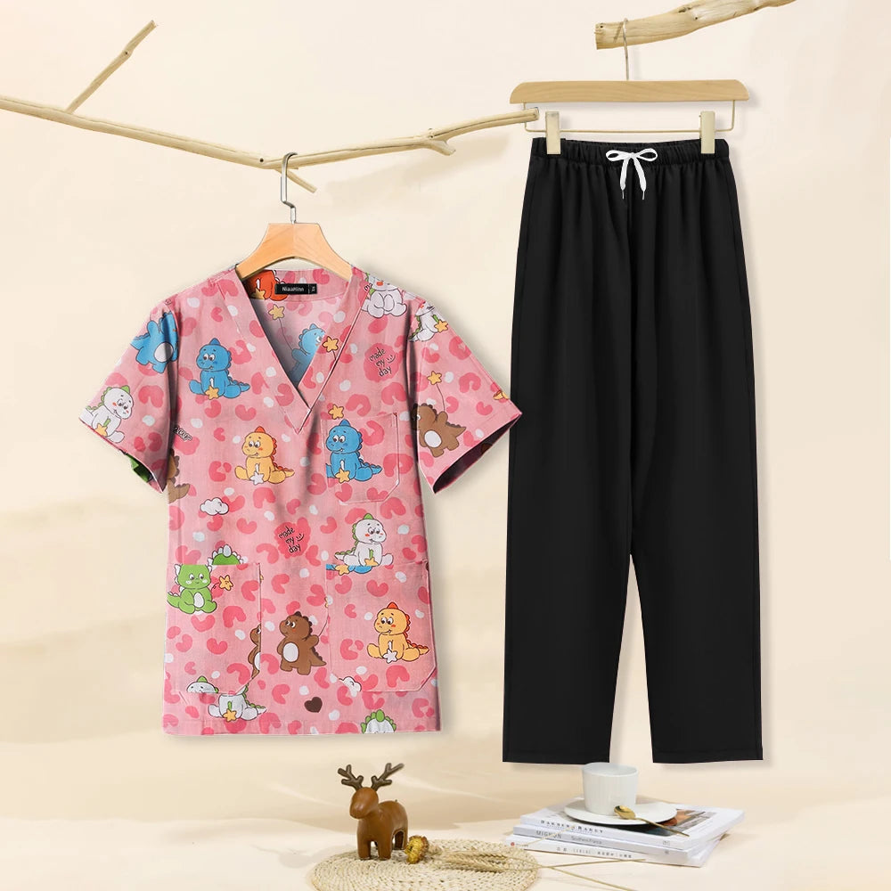 Cartoon print dental scrubs set featuring a pink top with playful characters and black pants, perfect for pet grooming and beauty salons.