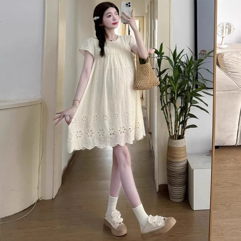 A-line cotton maternity dress in hollowed out style, perfect for summer wear, featuring a knee-length cut and light natural color.