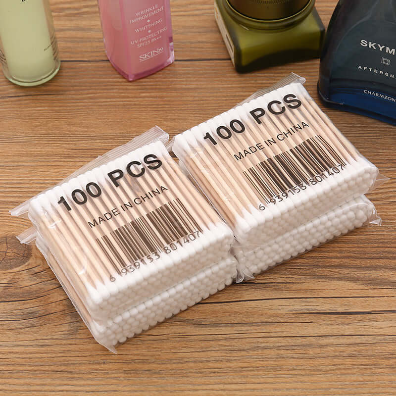 100 pcs bag of baby cotton swabs made in China, featuring wooden sticks and soft cotton tips for gentle use.
