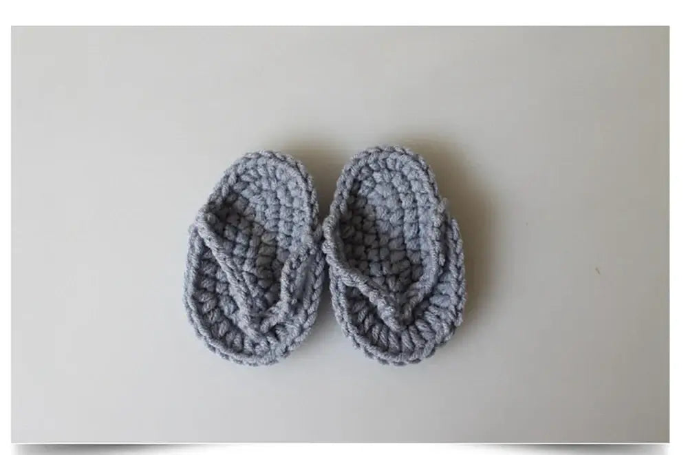 Soft gray crocheted baby flip flops, perfect for infant wear, designed for comfort and style, suitable for new parents.