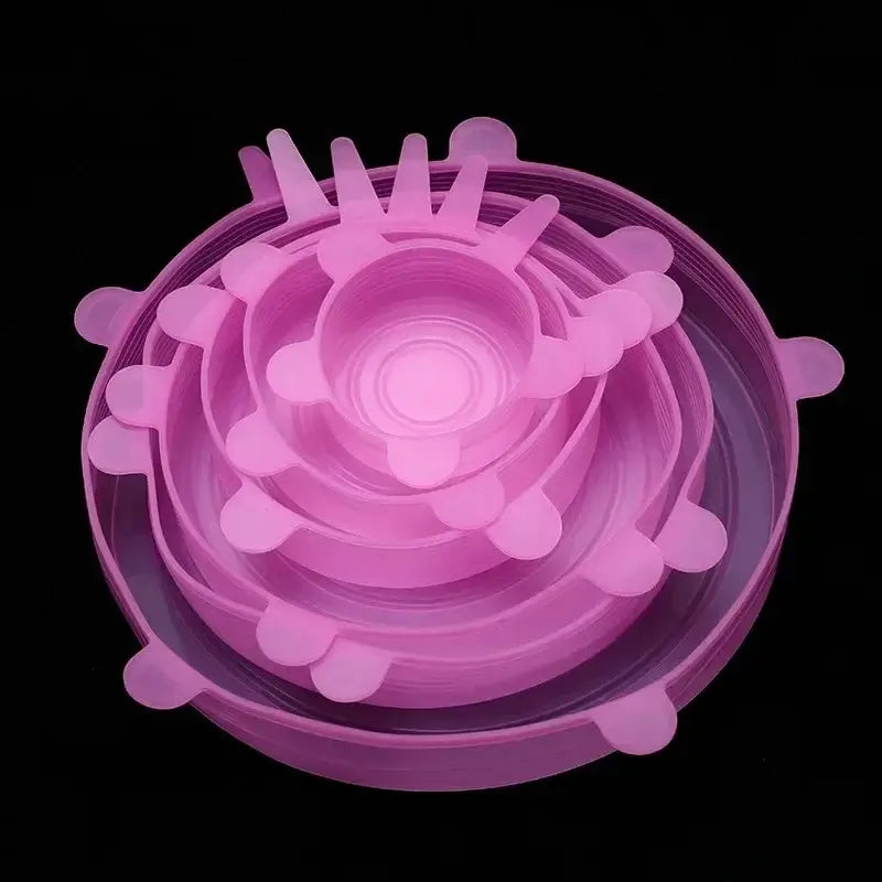Set of adjustable pink silicone food covers stacked together, designed for airtight food storage and freshness.