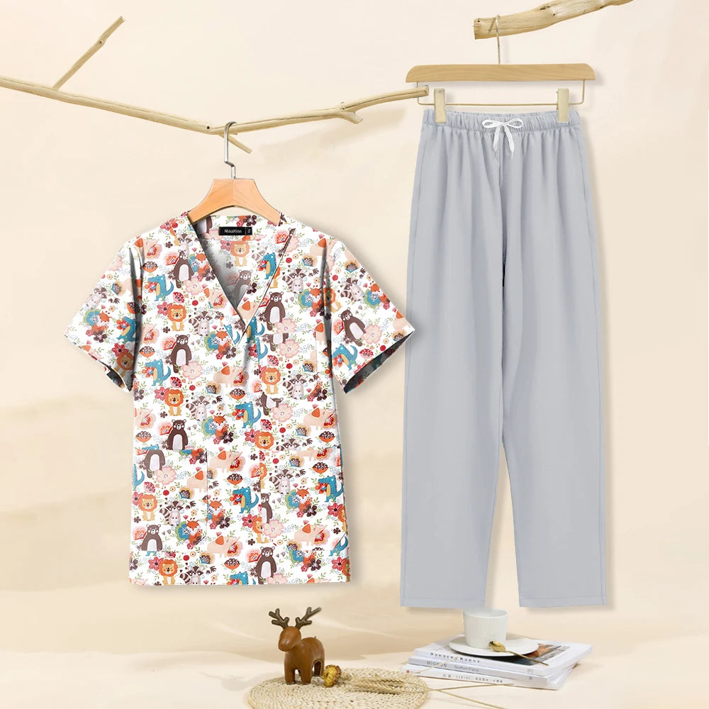 Cartoon print women's dental scrubs set with V-neck top and grey pants, perfect for pet grooming professionals.