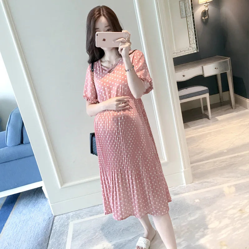 Chiffon polka dot maternity dress in pink, featuring short sleeves and a casual boat neck, perfect for summer wear.