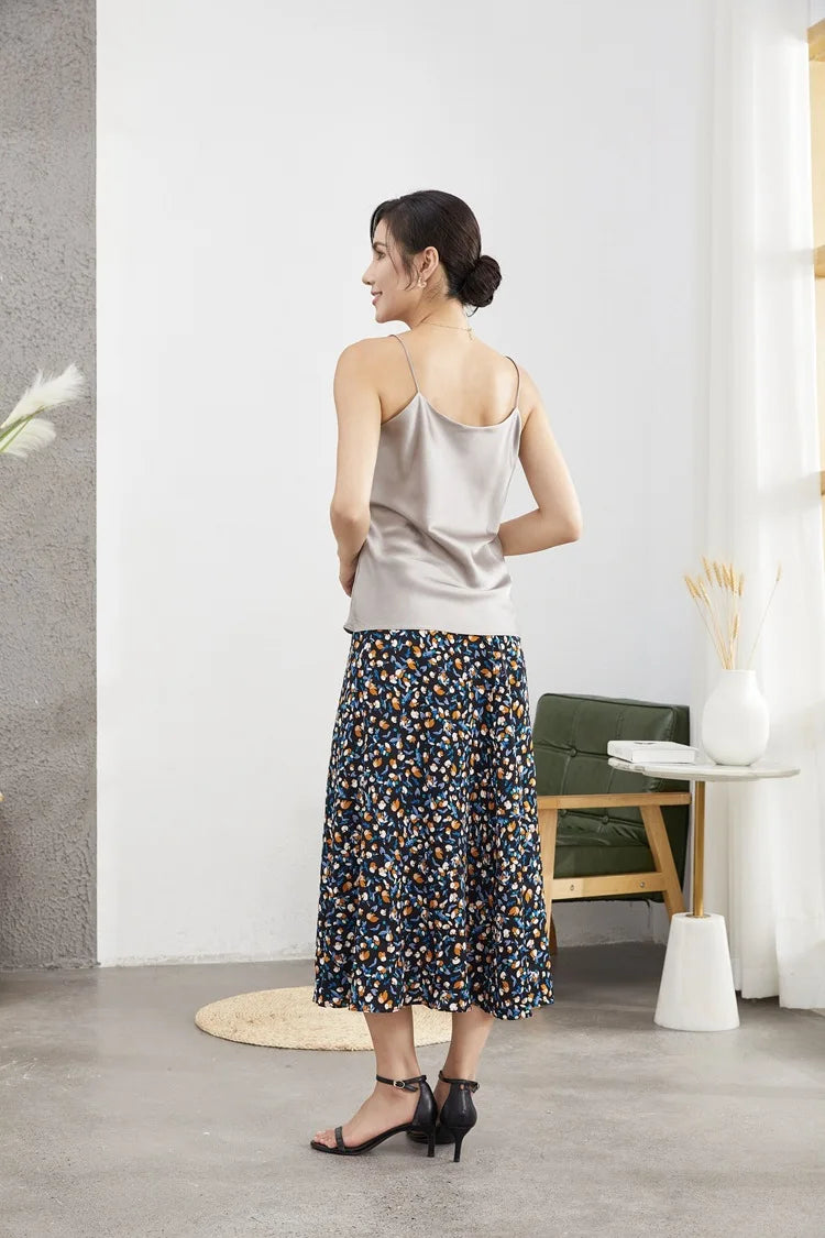 Back view of a woman wearing a double-layer silk camisole with a floral skirt, showcasing summer casual style.