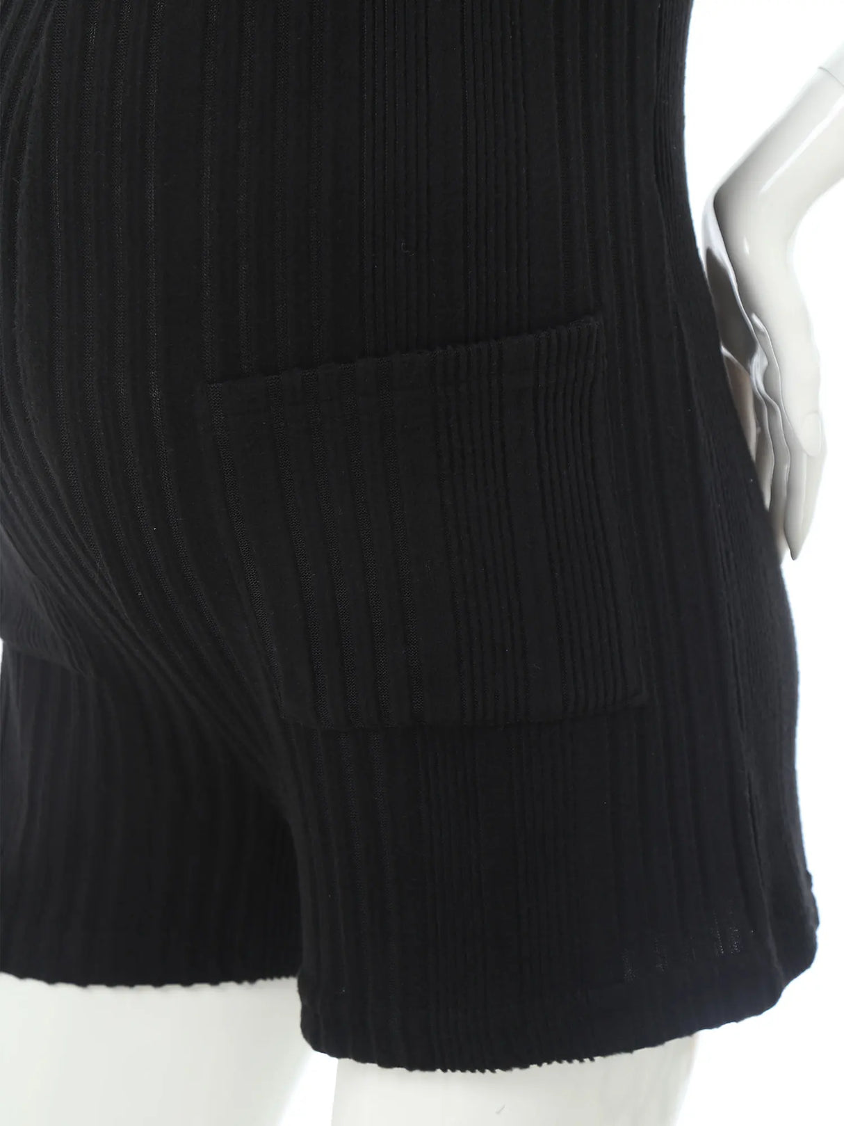 Close-up of black sleeveless ribbed maternity jumpsuit with pockets, perfect for casual summer wear.