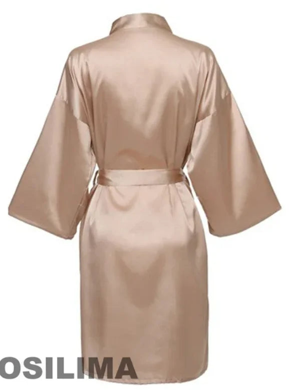 Back view of a knee-length satin bridesmaid robe in a soft beige hue with short sleeves and a belt.