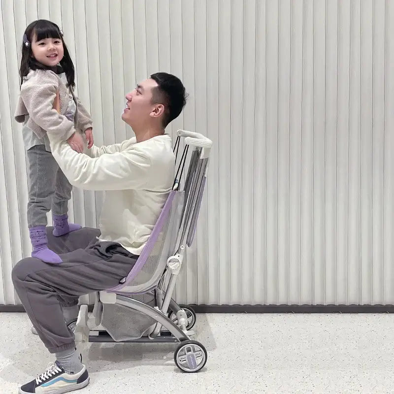 Father and daughter enjoying quality time with an outdoor lightweight children's stroller in a modern setting.