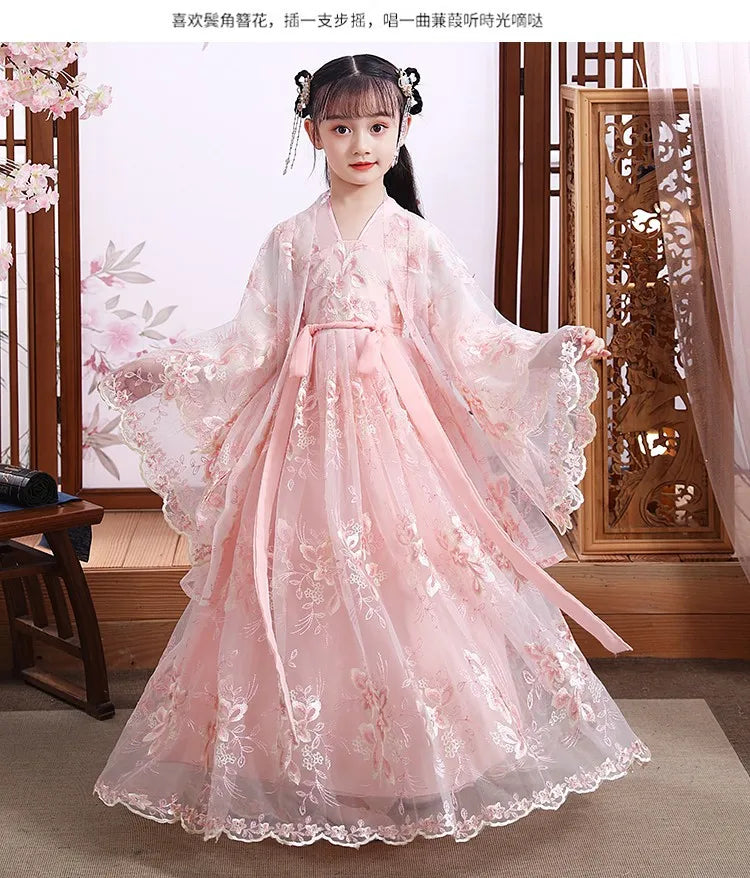 Elegant girl in a pink modern fairy hanfu cosplay dress with floral details and flowing sleeves.