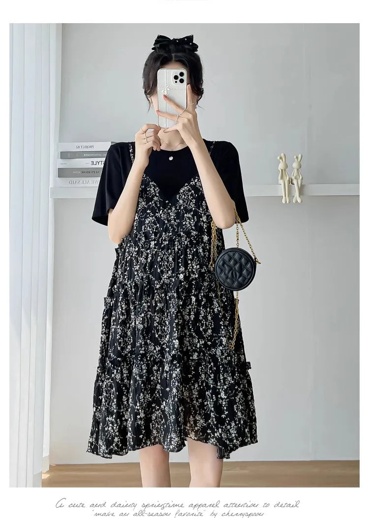 Elegant black floral maternity dress with ruffled layers, perfect for summer baby showers and stylish outings.