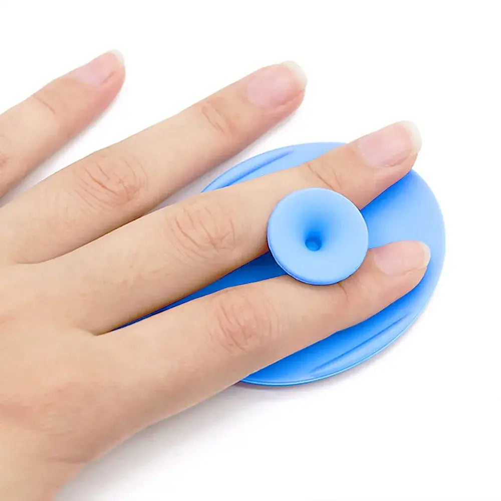 Hand holding a blue silicone baby bath brush, designed for newborns and infants, demonstrating its ergonomic grip.