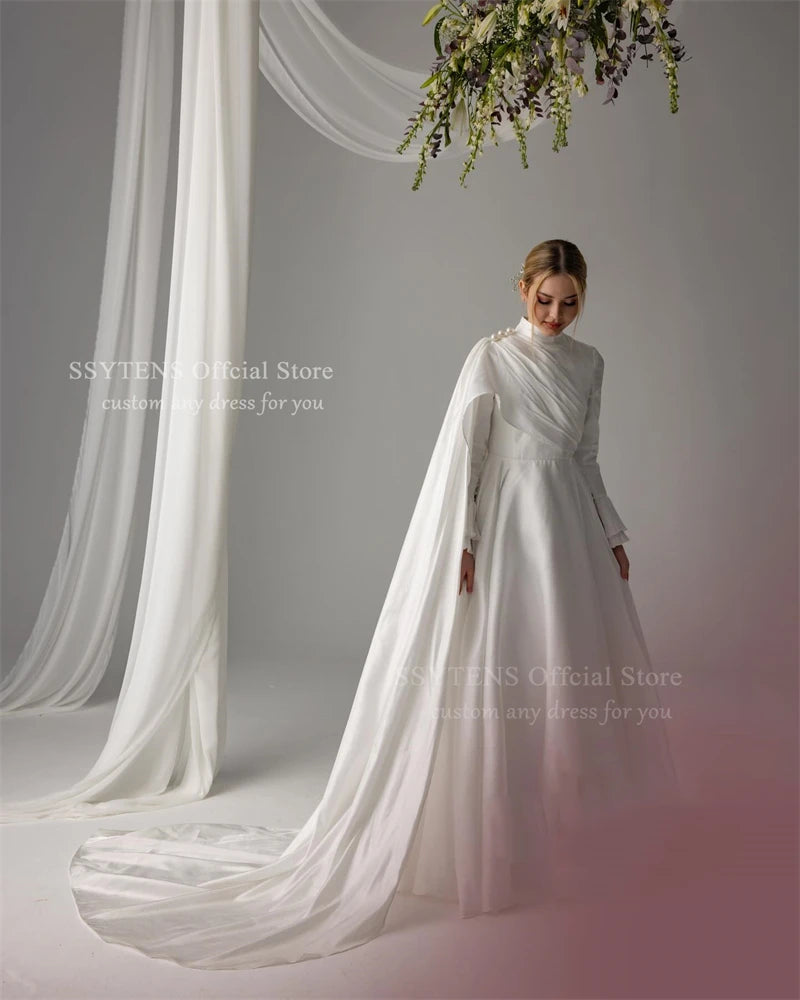 Elegant Muslim satin wedding dress featuring pearls, high neck, long sleeves, and a flowing train.