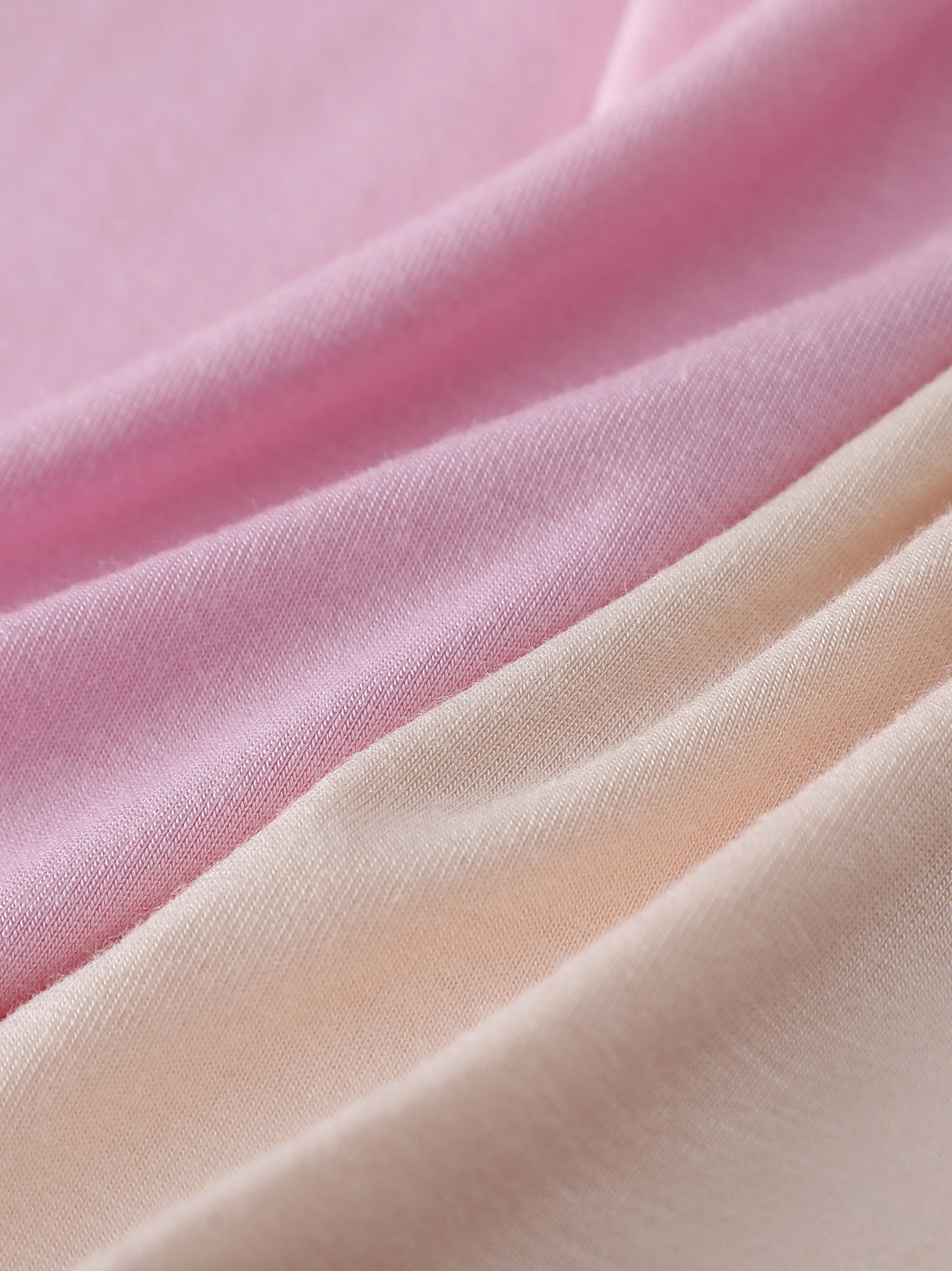 Soft fabric swatches showing shades of pink and beige, ideal for making comfortable camisoles and tops.