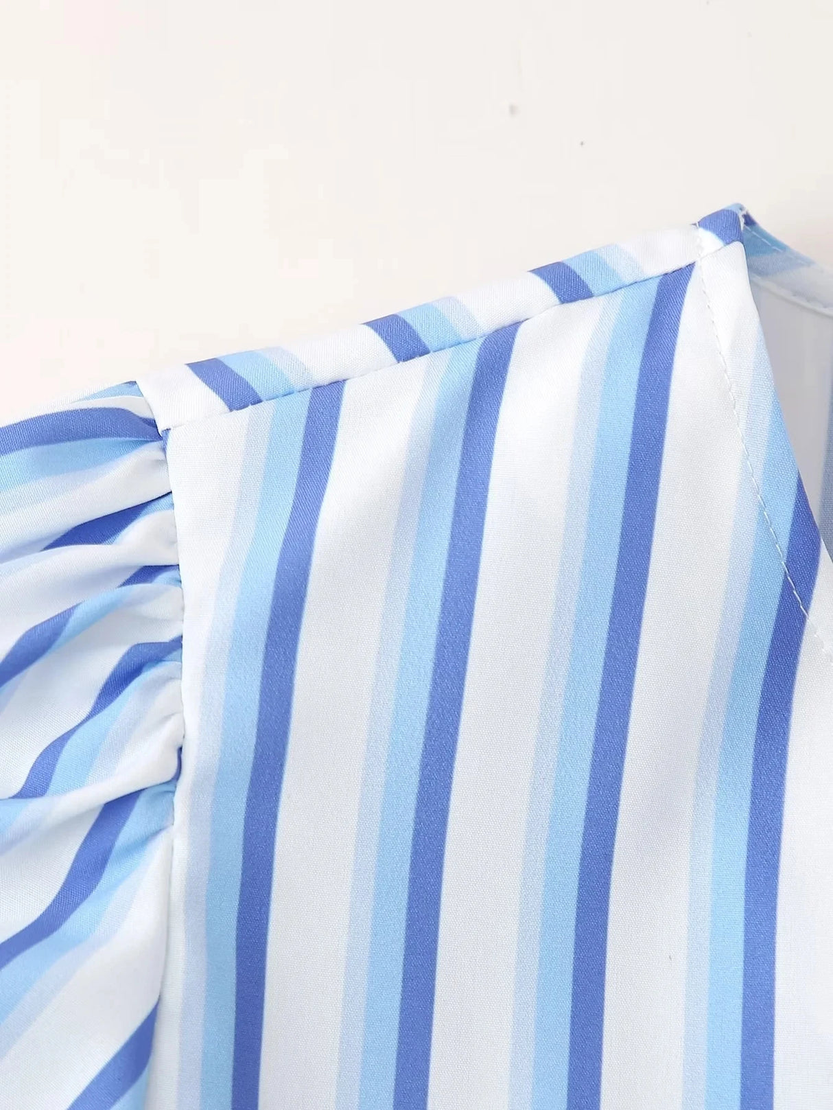 Close-up of BowChic™ Stripe Lace-Up Blouse featuring blue and white stripes and short sleeves.