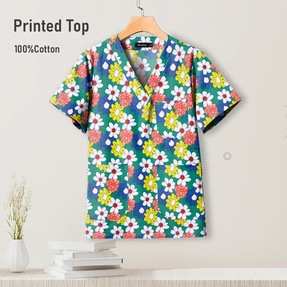 Colorful pediatric nursing scrub top with floral print, 100% cotton, breathable fabric for comfort.