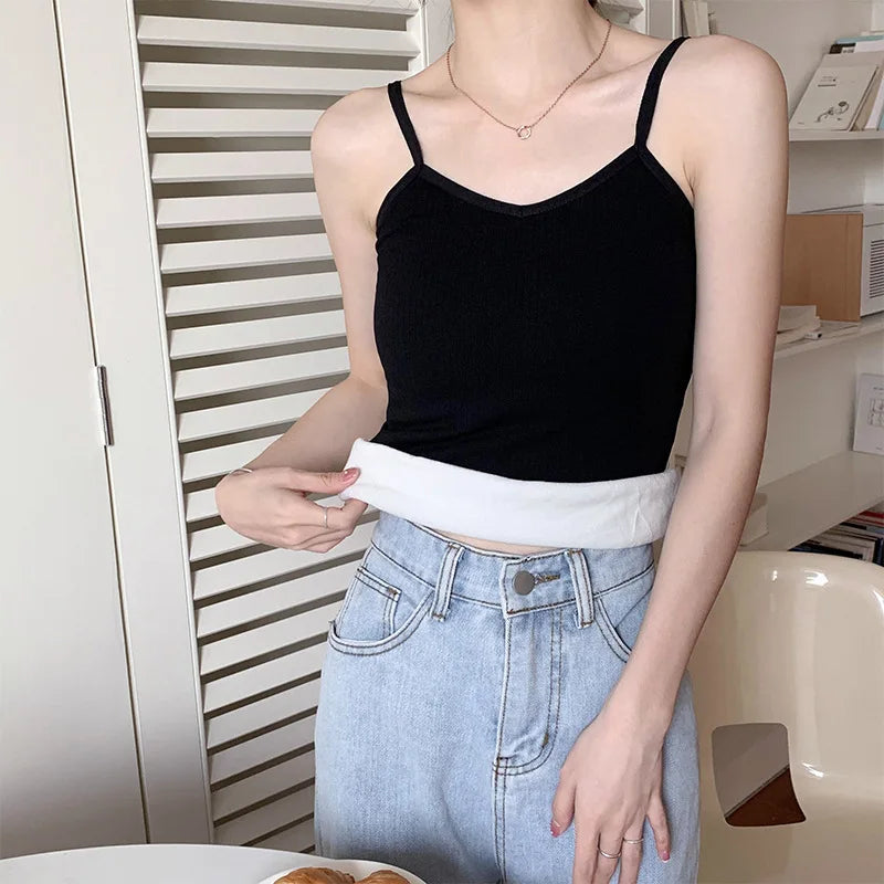Casual black velvet crop tank top layered over white fabric, perfect for women, styled with high-waisted denim.