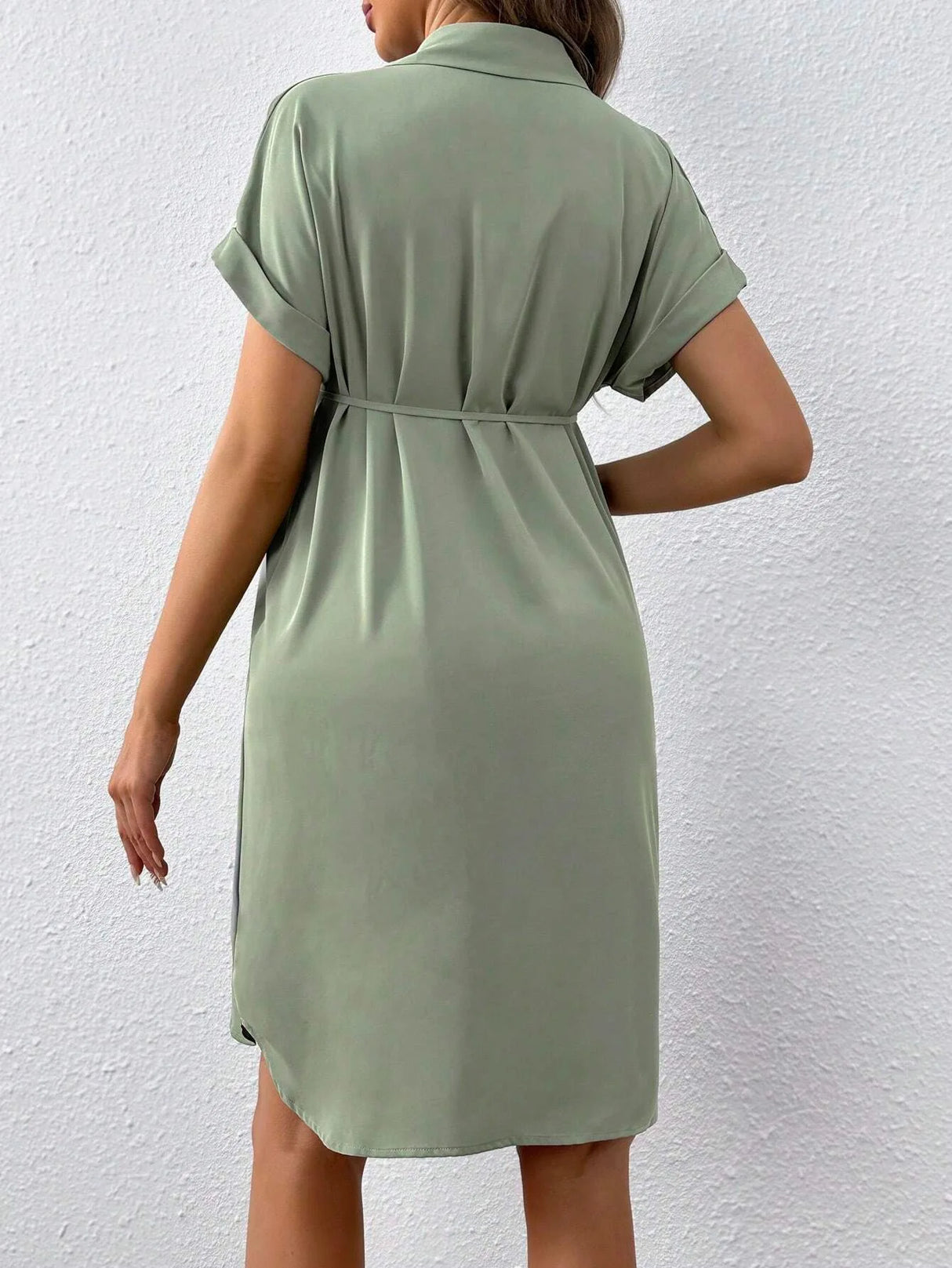Back view of a casual green maternity button shirt dress, featuring a turn-down collar and rolled sleeves.