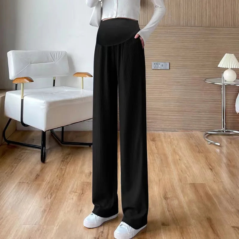 Stylish black ice silk pleated maternity pants showcased in a modern interior, perfect for summer wear.