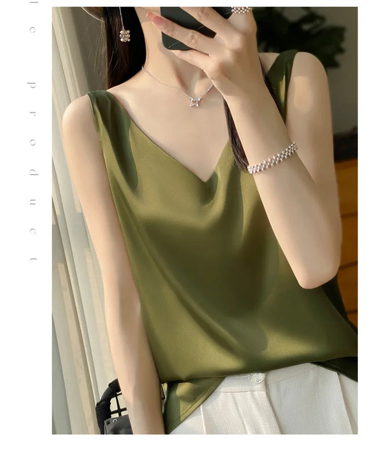 Model wearing a stylish olive green satin camisole with a v-neck design, perfect for summer fashion.
