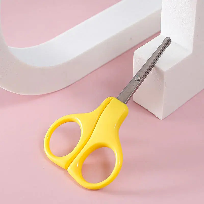 Yellow children's scissors designed for small hands, ideal for crafting and safe use by kids.