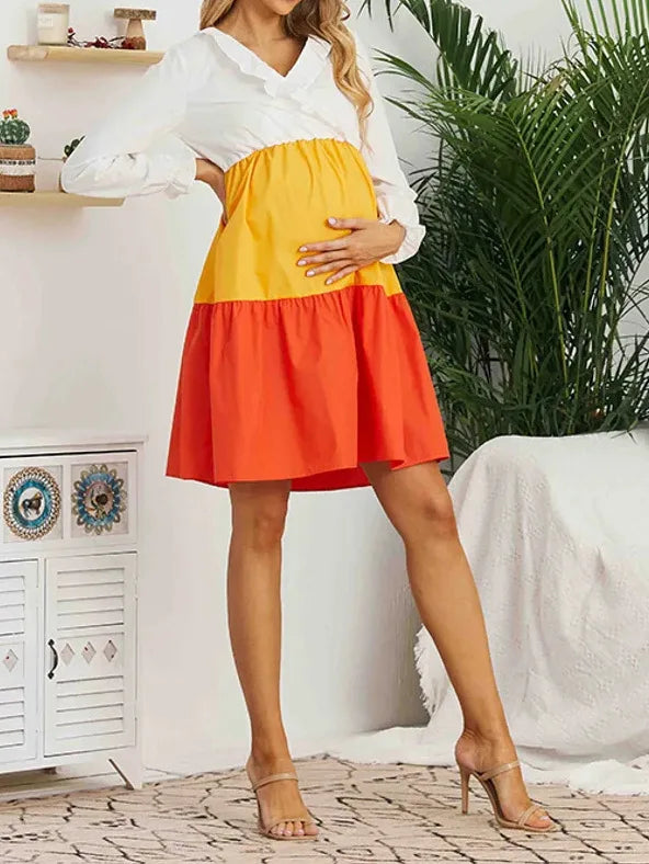 V-Neck color contrast maternity dress with long sleeves, featuring yellow and orange sections, perfect for summer wear.